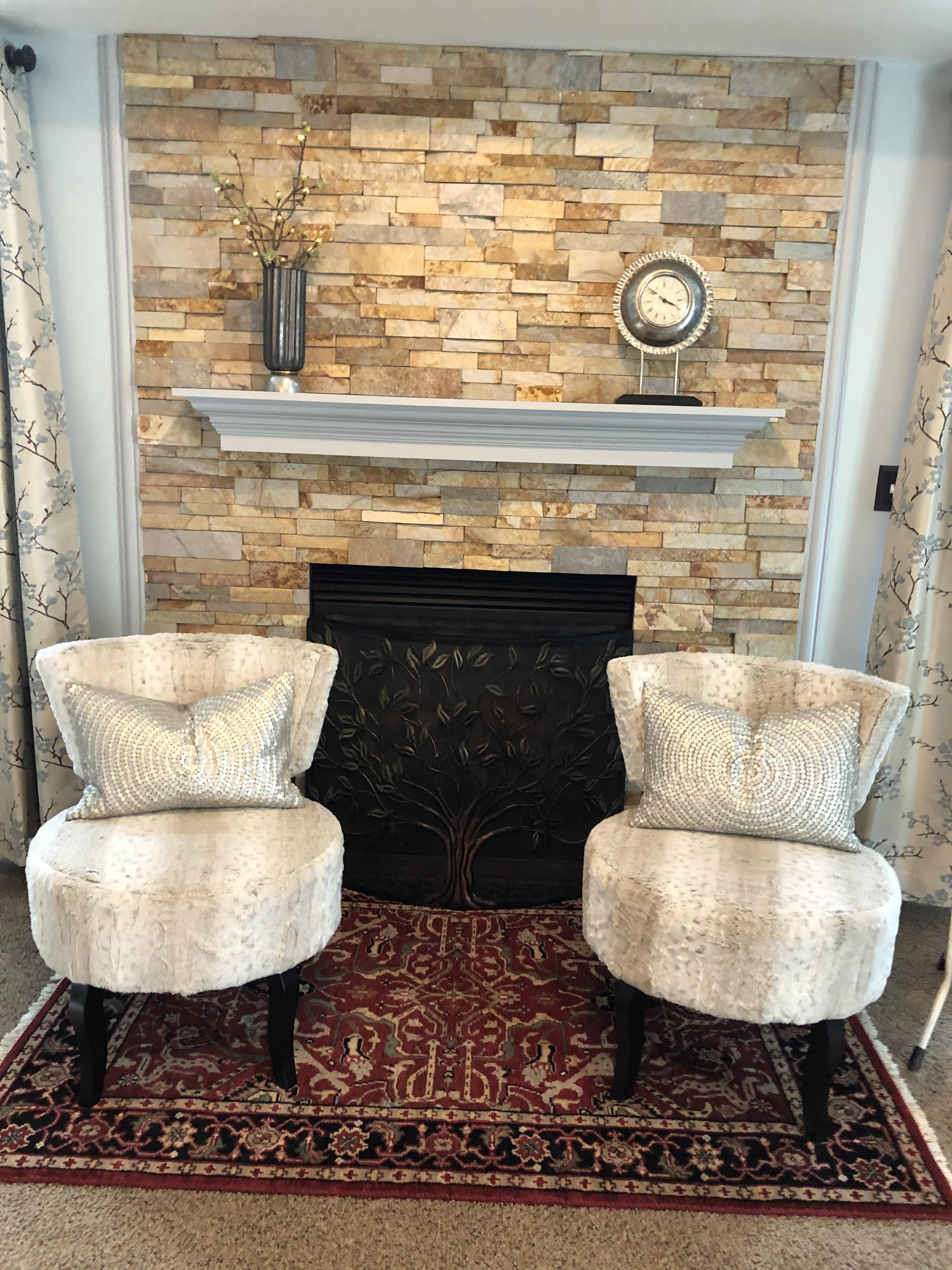 Before and after photos of a residential fireplace renovation project featuring Norstone Aztec XL Series Rock Panels